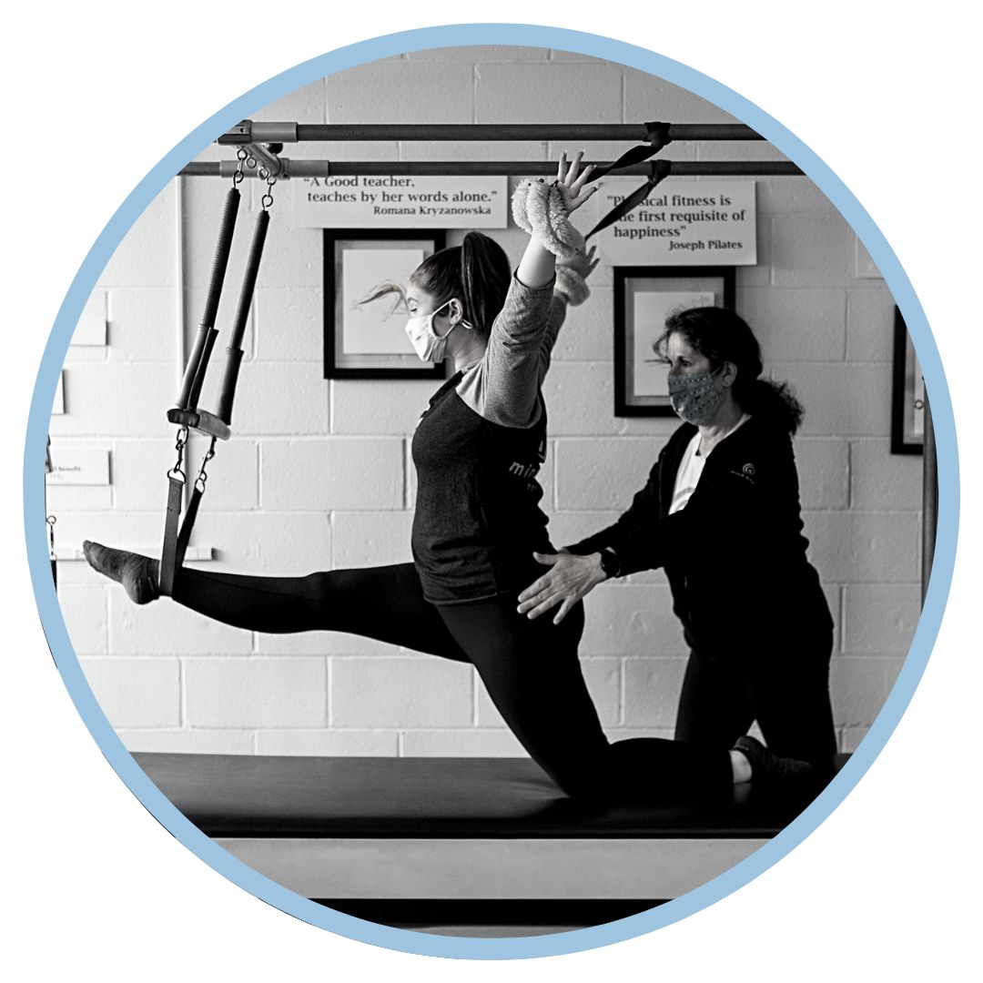 Mind Body instructor guiding a client on the Tower