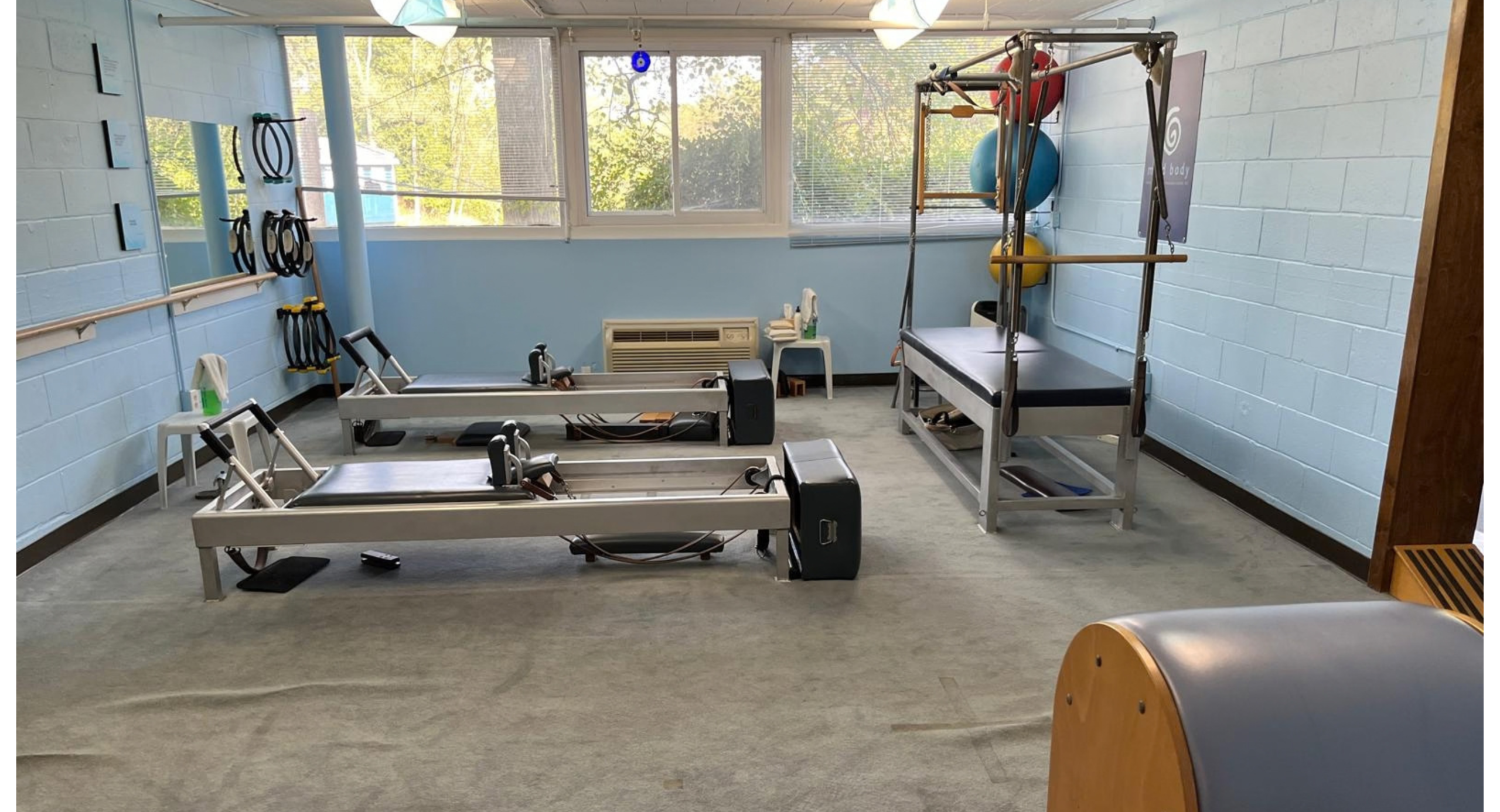 The Mind Body studio floor with Gratz Reformers, Cadillacs, and Chairs